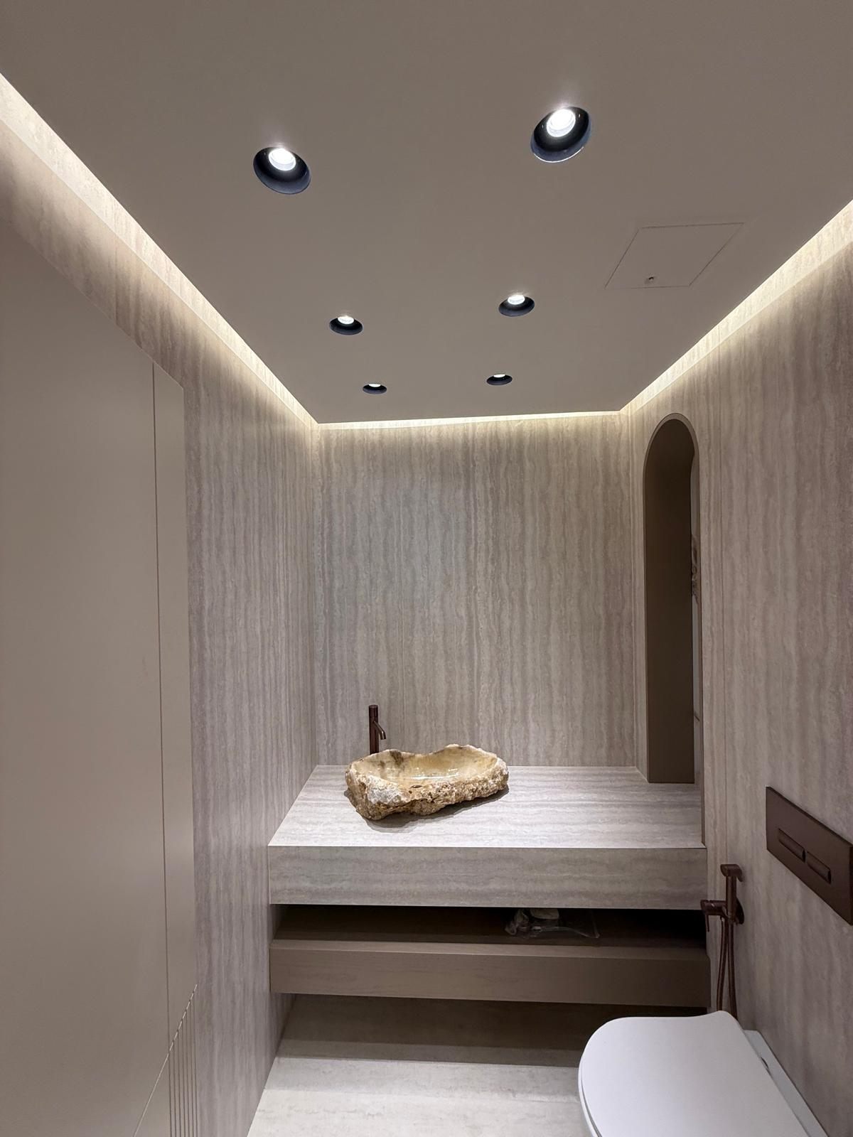 Floating travertine shelf with a stone basin