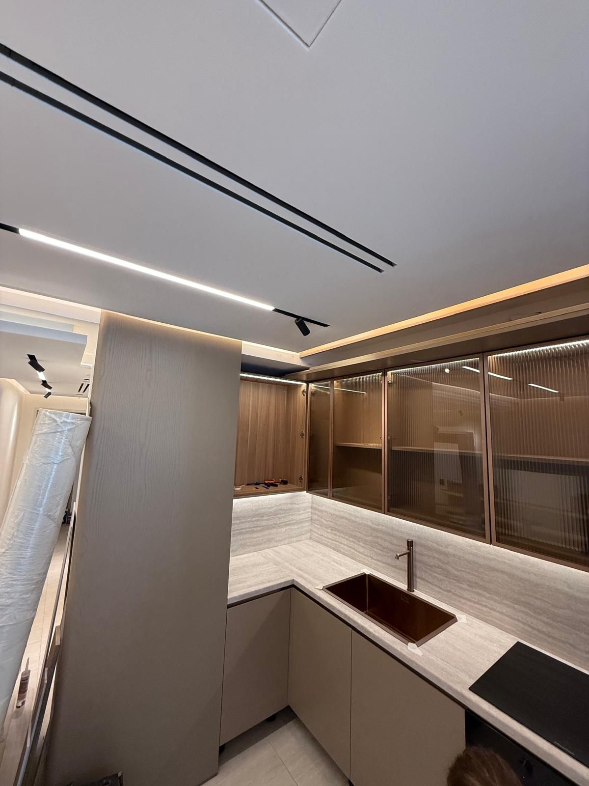 L-shaped kitchenette with LED under-cabinet lighting