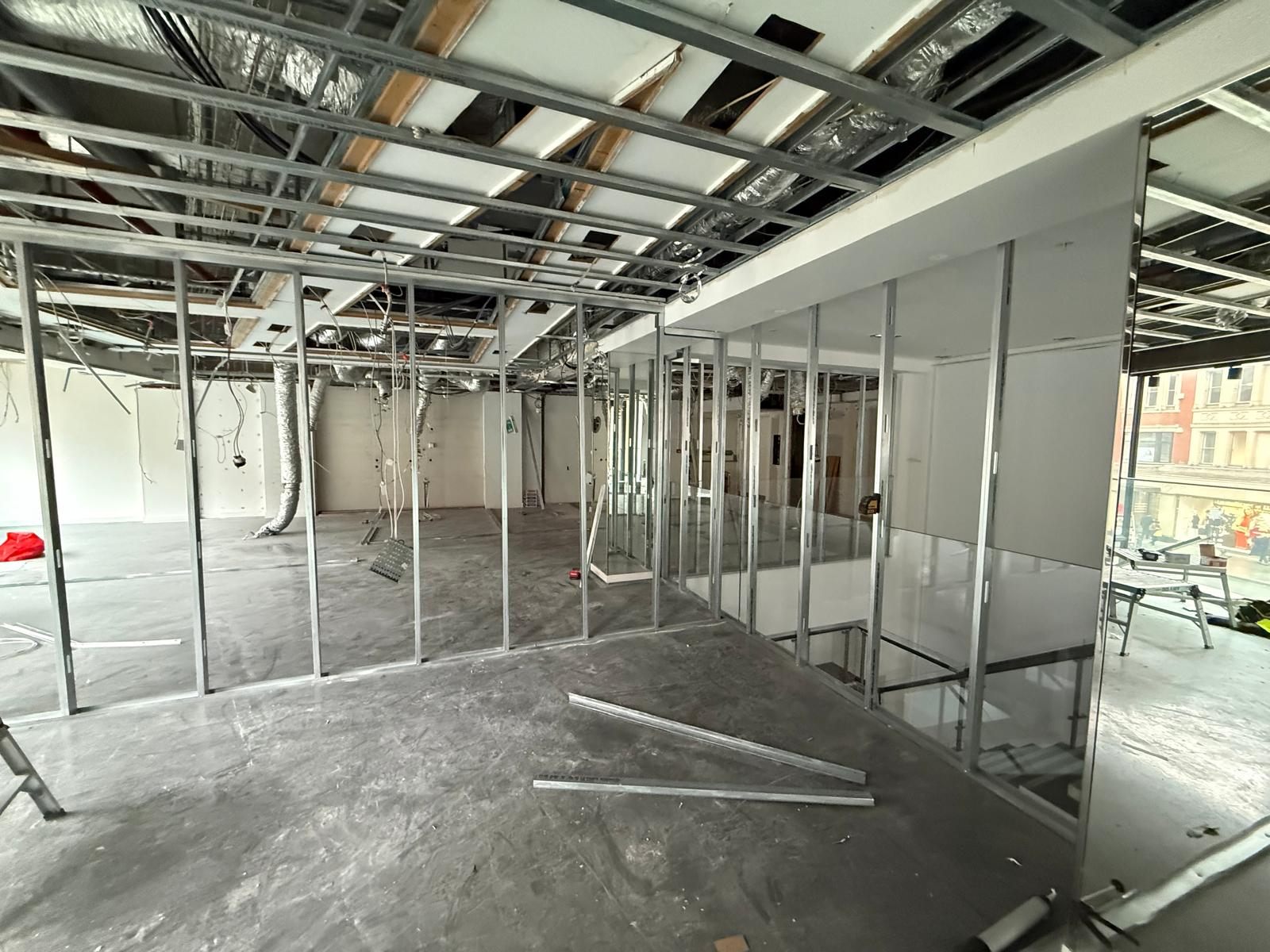 Open floor with the new metal stud walls going up