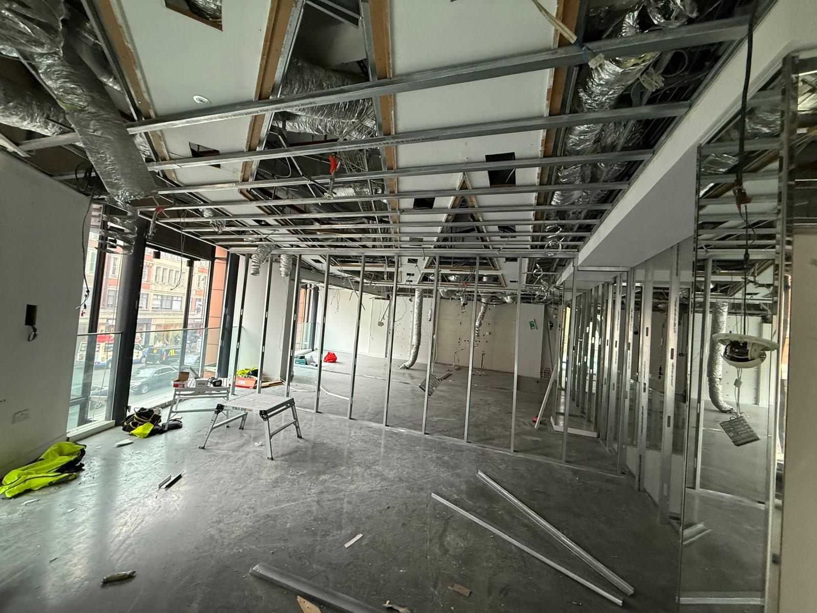 Ceiling grid and stud walls on an open commercial floor